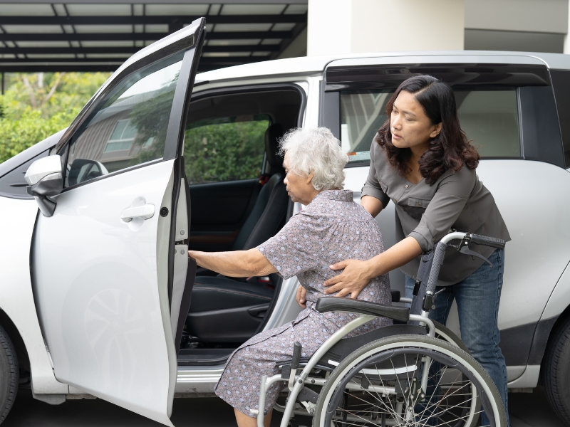 Caregiver helping a senior with transportation services for medical appointments in Middlesex County, MA