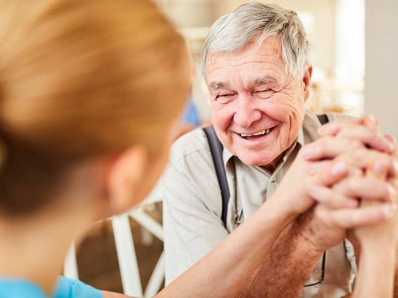 Caregiver assisting elderly man with personal care services at home in Middlesex County, MA