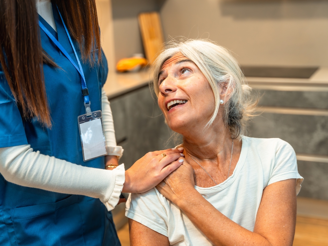 Caregiver assisting a senior woman with assisted living support services at home in Middlesex County, MA
